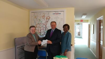 IBERIABANK President Taylor Barras, presents checks totaling $50,000